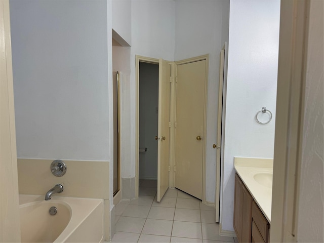 full bath featuring a shower stall, a garden tub, vanity, and tile patterned floors