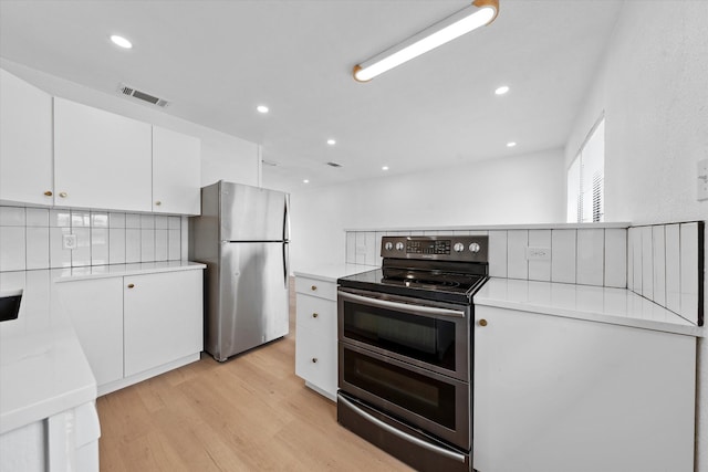 kitchen featuring light countertops, visible vents, appliances with stainless steel finishes, light wood-style floors, and white cabinetry