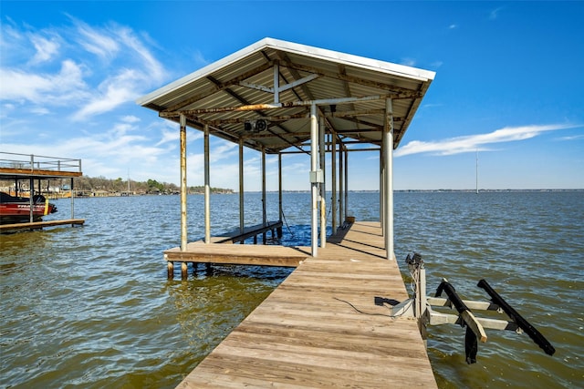 view of dock featuring a water view and boat lift