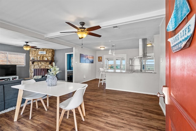 dining area featuring a ceiling fan, visible vents, baseboards, beam ceiling, and dark wood-style floors