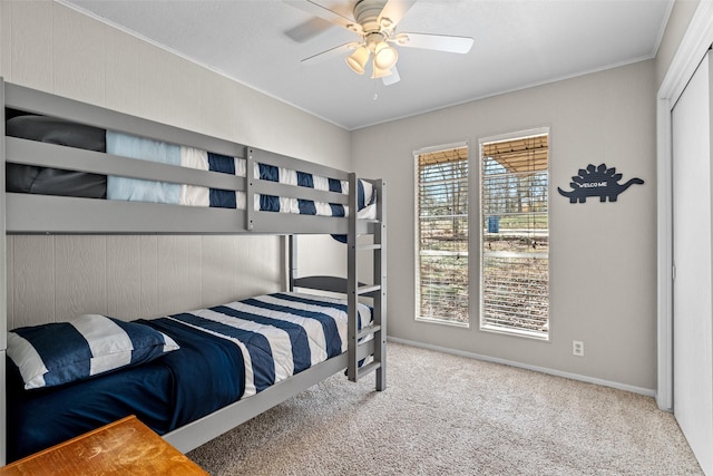 bedroom featuring ceiling fan, baseboards, carpet flooring, and ornamental molding