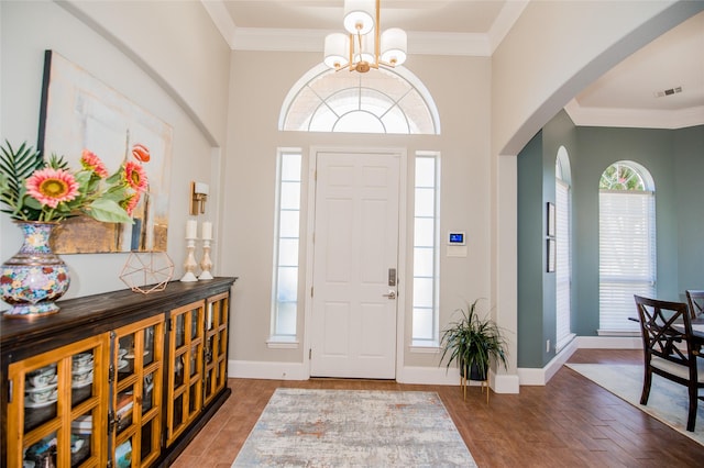 entryway featuring ornamental molding and wood finished floors