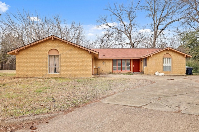 single story home featuring brick siding