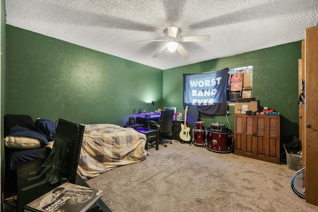 bedroom featuring a ceiling fan, carpet, a textured wall, and a textured ceiling