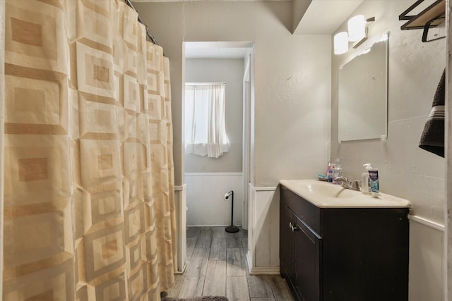 full bath featuring wood tiled floor and vanity