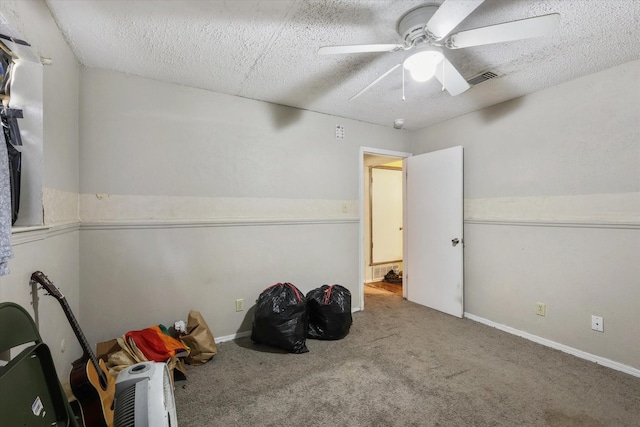 interior space with carpet floors, visible vents, and a textured ceiling