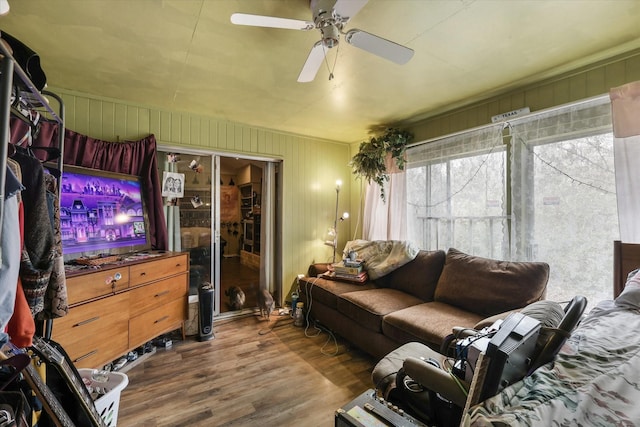 living room with wood finished floors and a ceiling fan