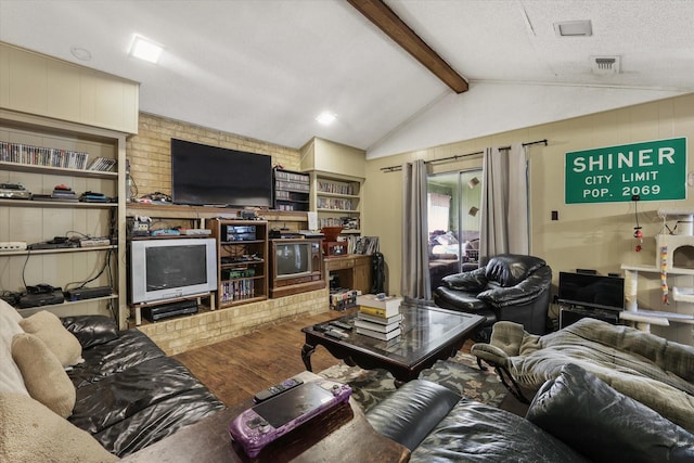 living room featuring vaulted ceiling with beams, a textured ceiling, visible vents, and wood finished floors