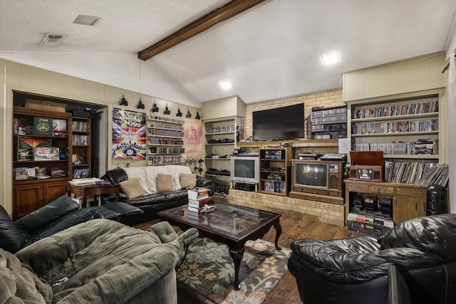 living room featuring vaulted ceiling with beams, a textured ceiling, a fireplace, wood finished floors, and visible vents