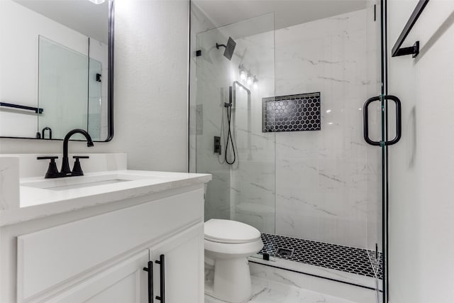 full bathroom with a marble finish shower, marble finish floor, vanity, and toilet