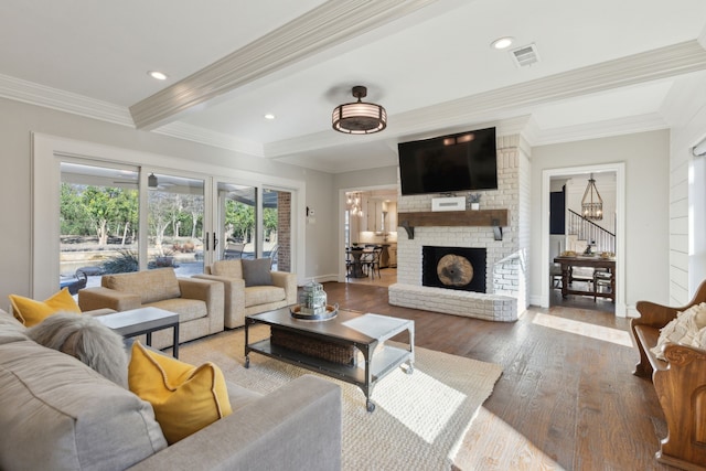 living area with beam ceiling, visible vents, crown molding, and wood finished floors