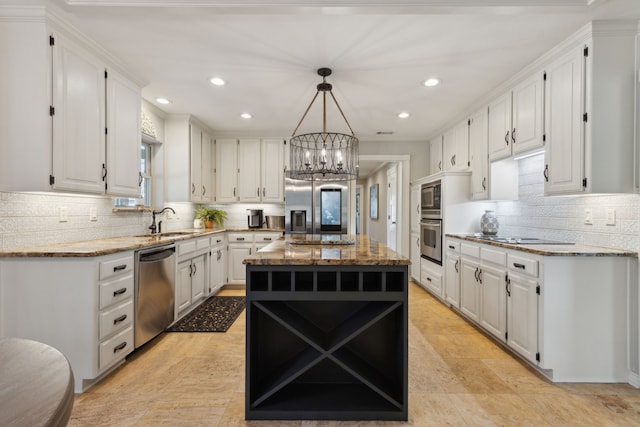 kitchen with light stone countertops, appliances with stainless steel finishes, white cabinets, and an inviting chandelier