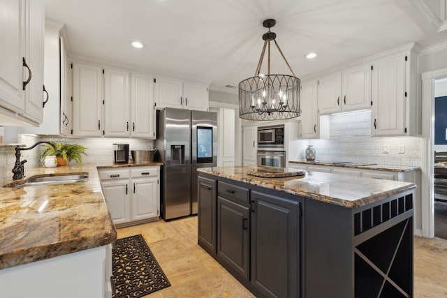 kitchen featuring a kitchen island, white cabinetry, stainless steel appliances, and a sink