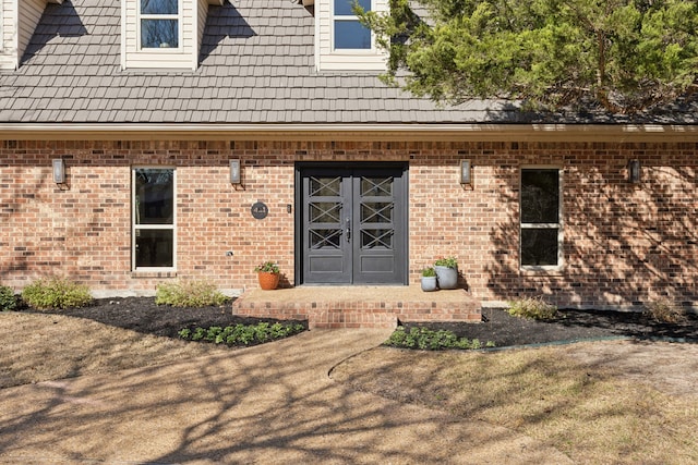 doorway to property with brick siding