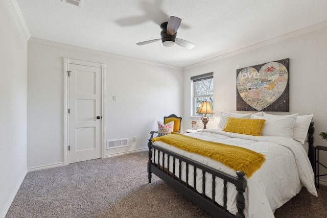 carpeted bedroom with a ceiling fan, crown molding, baseboards, and visible vents