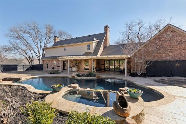 view of pool featuring a pool with connected hot tub, a fenced backyard, and a patio area