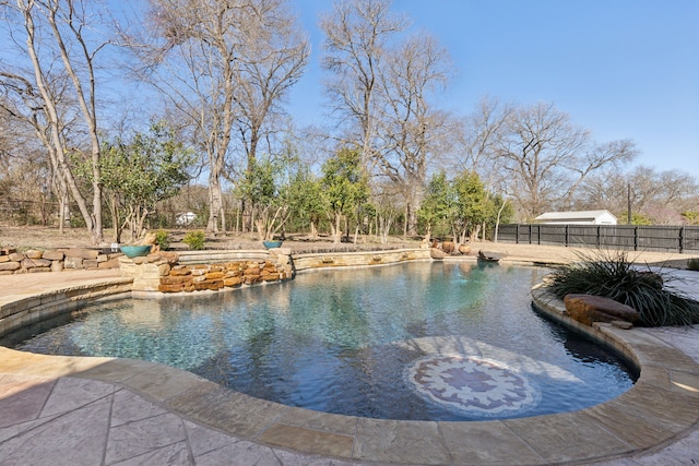 view of swimming pool featuring fence