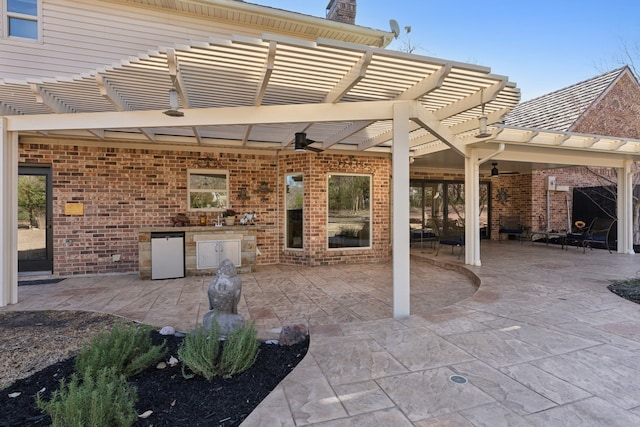 view of patio / terrace featuring an outdoor kitchen and a pergola