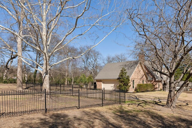 view of yard with an attached garage and fence