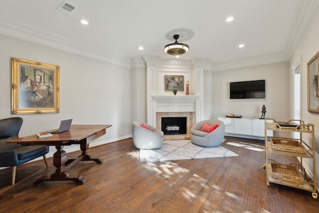 home office with crown molding, wood finished floors, a fireplace, and visible vents