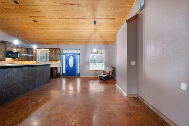 kitchen with lofted ceiling, black microwave, light countertops, and baseboards