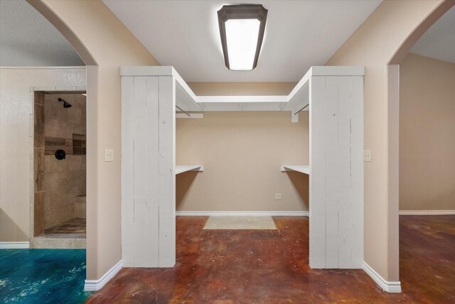 spacious closet with arched walkways
