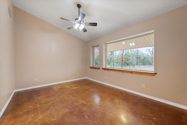 interior space with a ceiling fan, arched walkways, visible vents, and baseboards