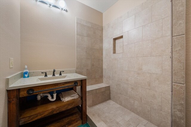 full bath featuring toilet, baseboards, and a tile shower