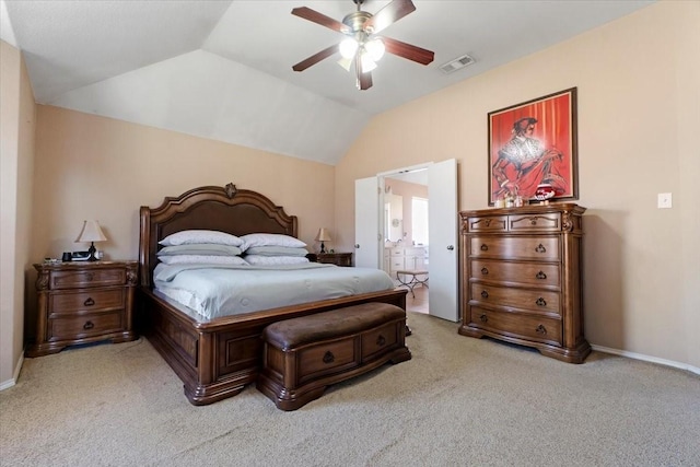 bedroom featuring light carpet, baseboards, visible vents, connected bathroom, and lofted ceiling