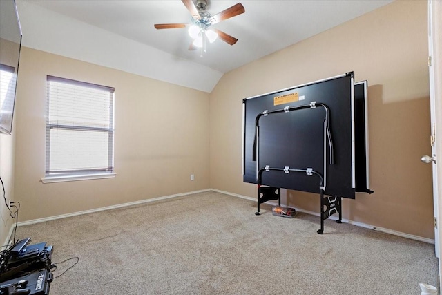 interior space featuring lofted ceiling, light carpet, ceiling fan, and baseboards