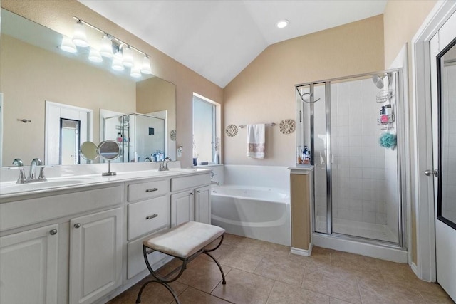 bathroom featuring a stall shower, vaulted ceiling, and a sink