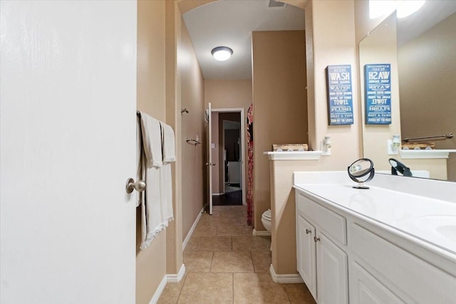 full bath featuring double vanity, baseboards, toilet, and tile patterned floors