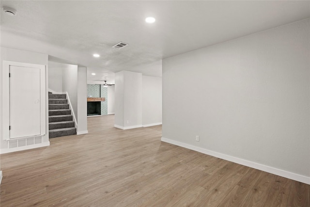 spare room featuring baseboards, visible vents, and light wood finished floors