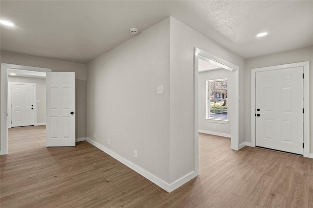 entrance foyer featuring light wood-type flooring, baseboards, and recessed lighting