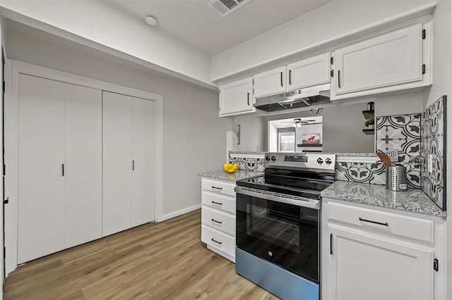 kitchen featuring under cabinet range hood, visible vents, white cabinetry, stainless steel electric range, and light stone countertops