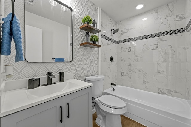 bathroom with shower / bath combination, wallpapered walls, visible vents, toilet, and vanity