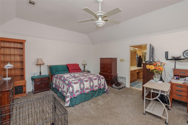 carpeted bedroom featuring lofted ceiling, visible vents, ceiling fan, and a textured ceiling