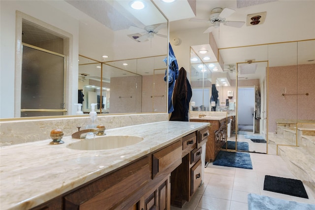 full bath featuring a ceiling fan, tile patterned flooring, a shower stall, and vanity