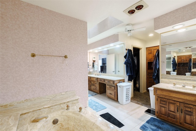 full bath with two vanities, a ceiling fan, a sink, tile patterned flooring, and wallpapered walls