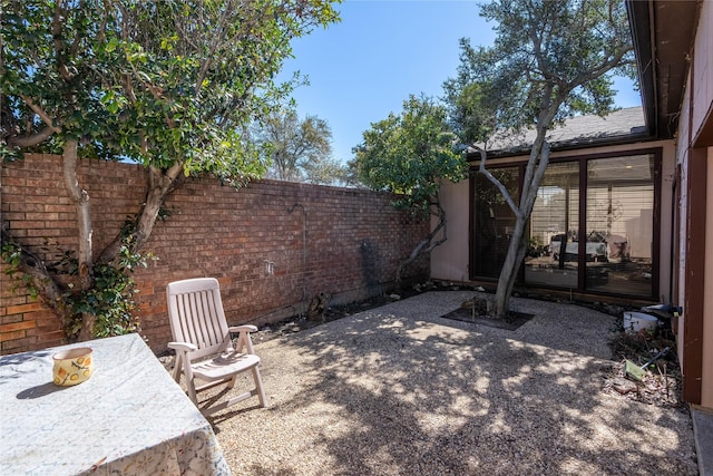 view of patio featuring fence