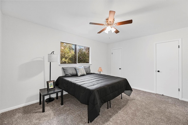 carpeted bedroom with a ceiling fan and baseboards