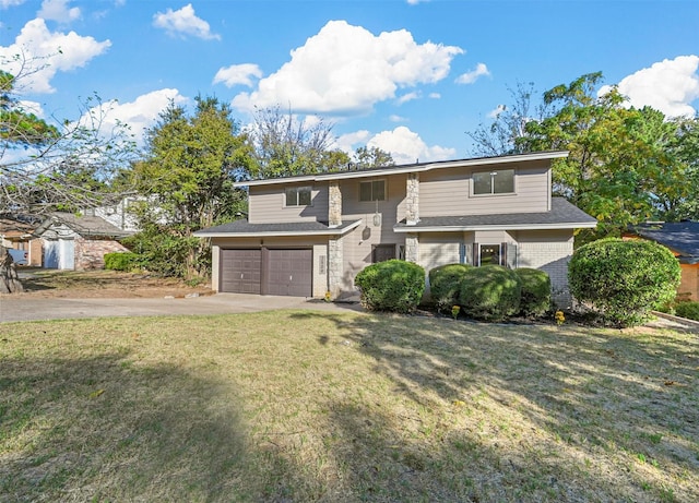 view of front facade featuring a garage, concrete driveway, a front lawn, and brick siding