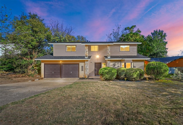 view of front facade featuring an attached garage, brick siding, concrete driveway, and a front yard