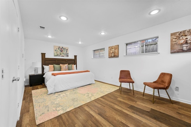 bedroom featuring baseboards, dark wood-style flooring, visible vents, and recessed lighting