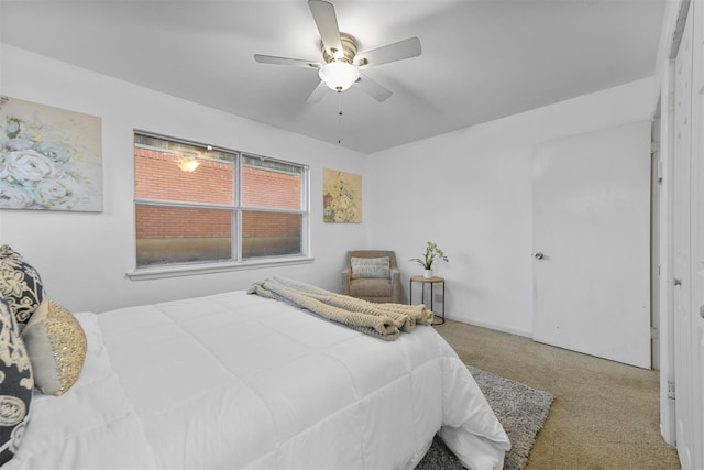 bedroom featuring light carpet and a ceiling fan