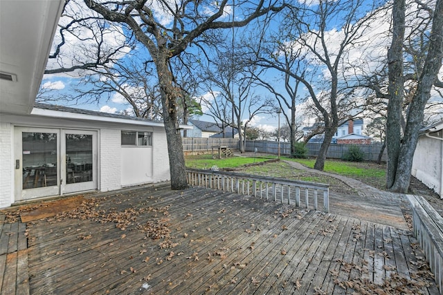 wooden deck featuring a fenced backyard and a yard