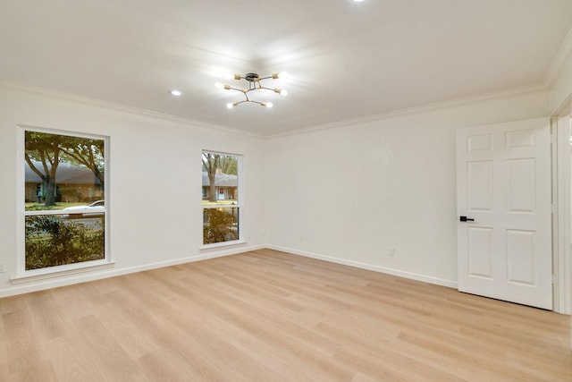 unfurnished room featuring light wood-style floors, a notable chandelier, ornamental molding, and baseboards