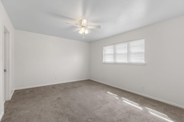 spare room with baseboards, carpet floors, and ceiling fan