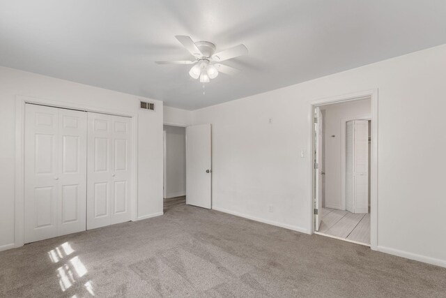 unfurnished bedroom featuring visible vents, baseboards, carpet, and a closet