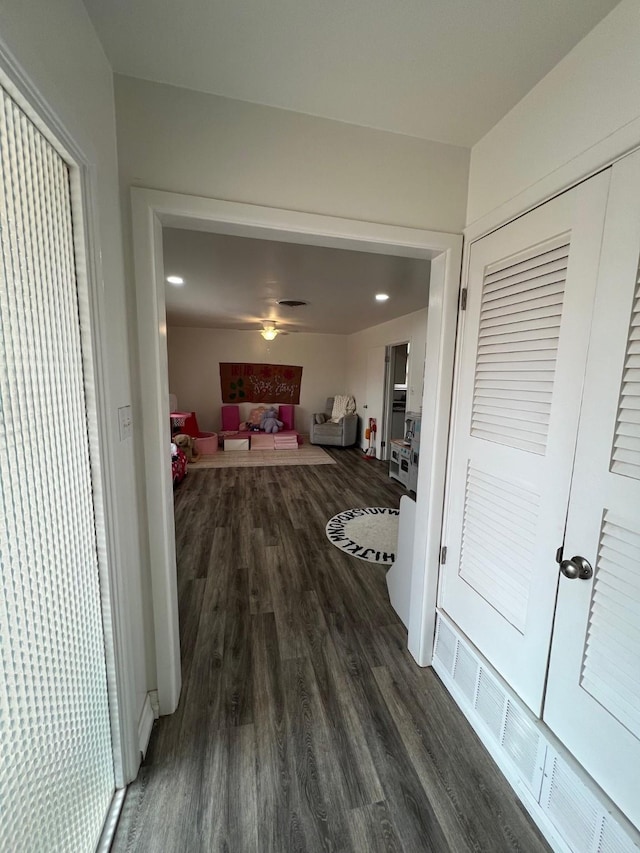 hall featuring recessed lighting and dark wood-type flooring